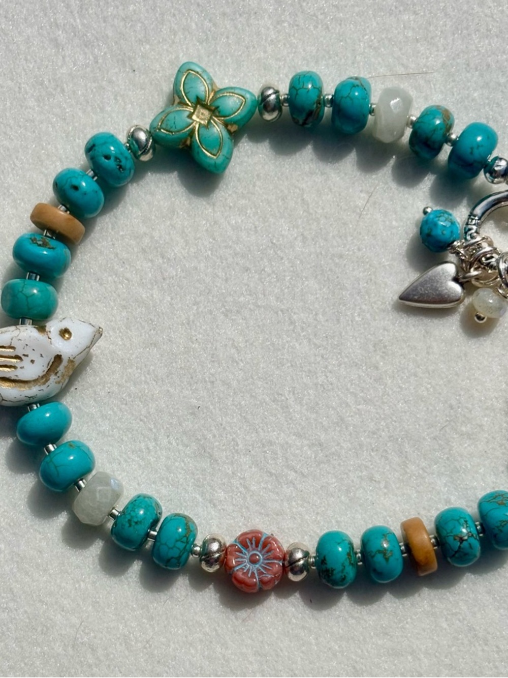Turquoise Beaded Charm Bracelet with Floral and Bird Accents